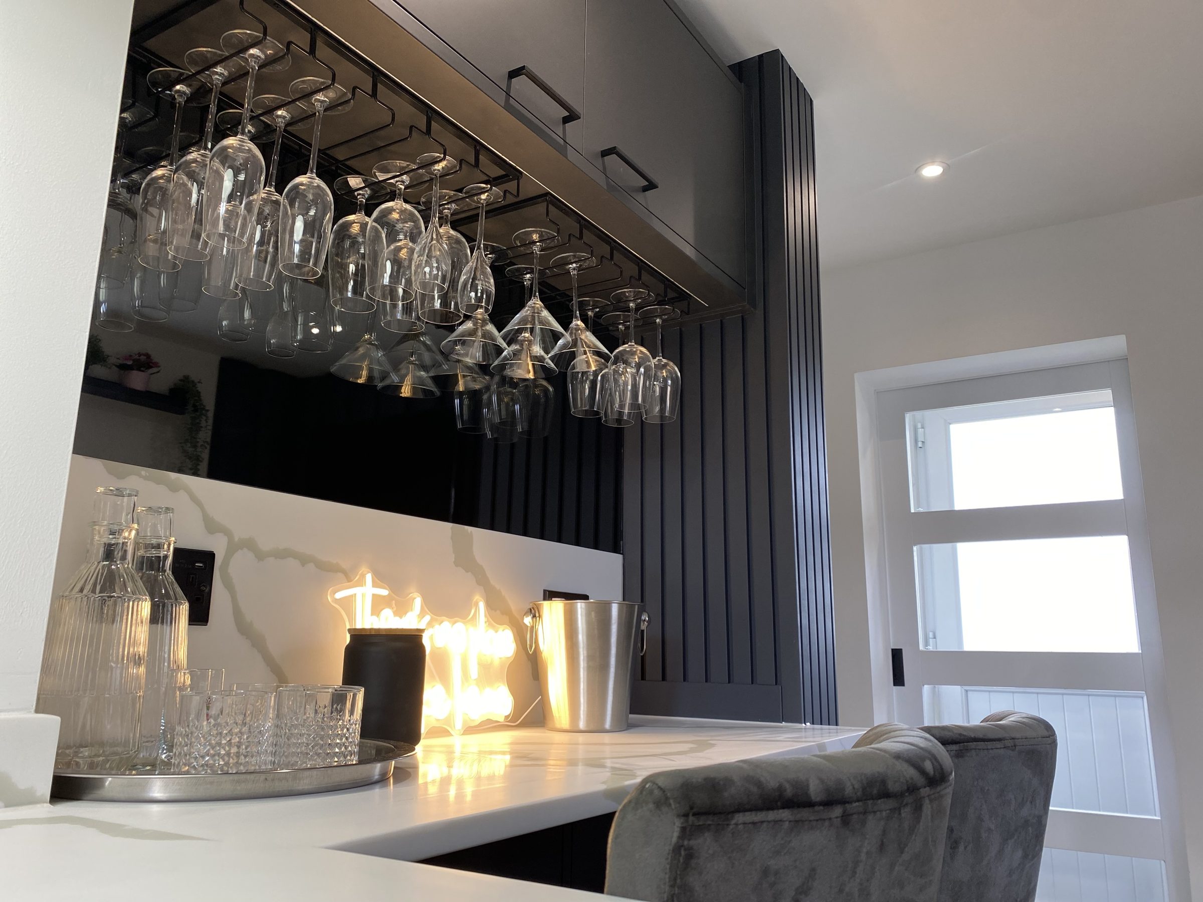 Panelled bar unit with fitted shelving and glassware by VIP Walls