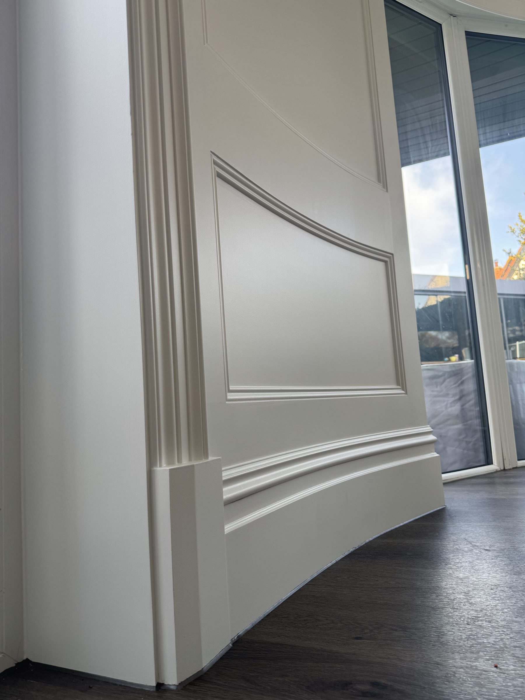 Panelling and moulding taken around a curved wall