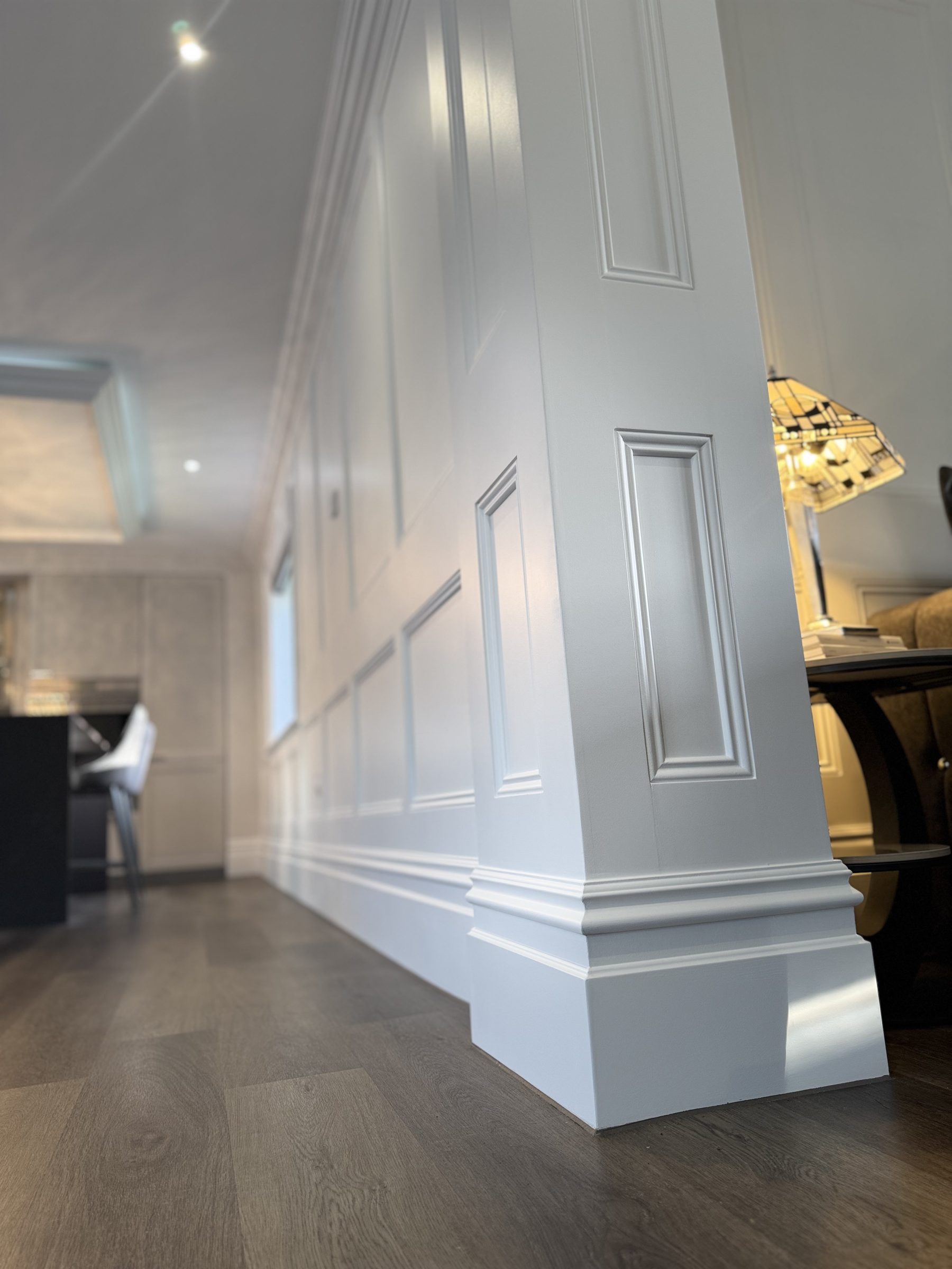 Painted wall panelling in a hallway and dining area, fitted by VIP Walls