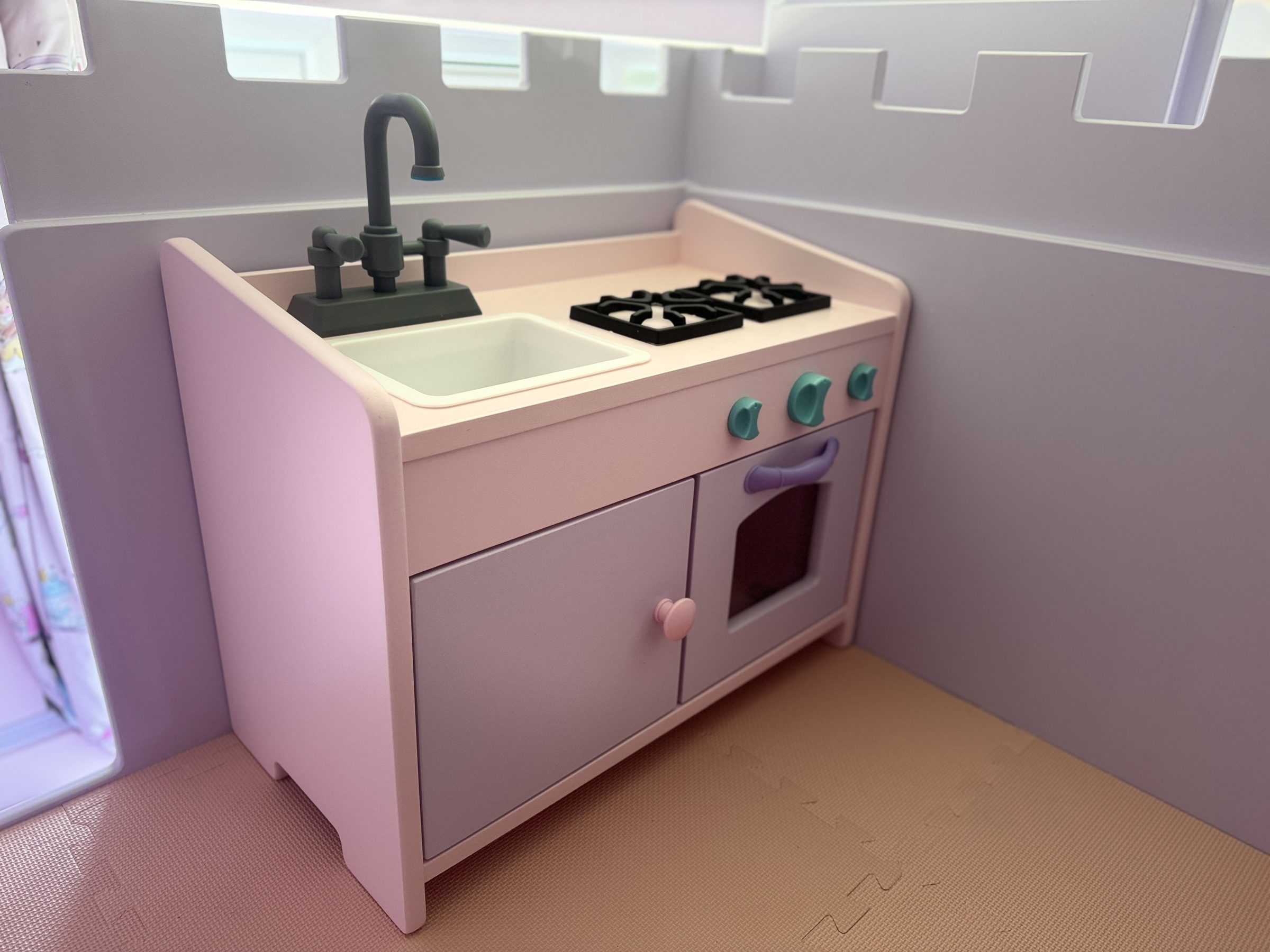 Handmade play kitchen fitted into a child's bedroom