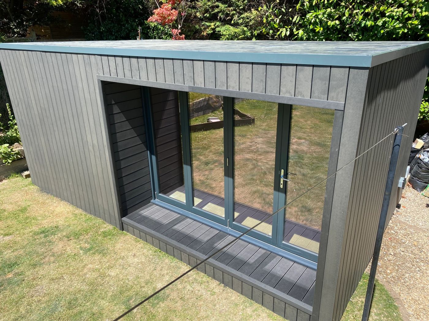 Garden room with grey cladding and full height glazing built by VIP Walls