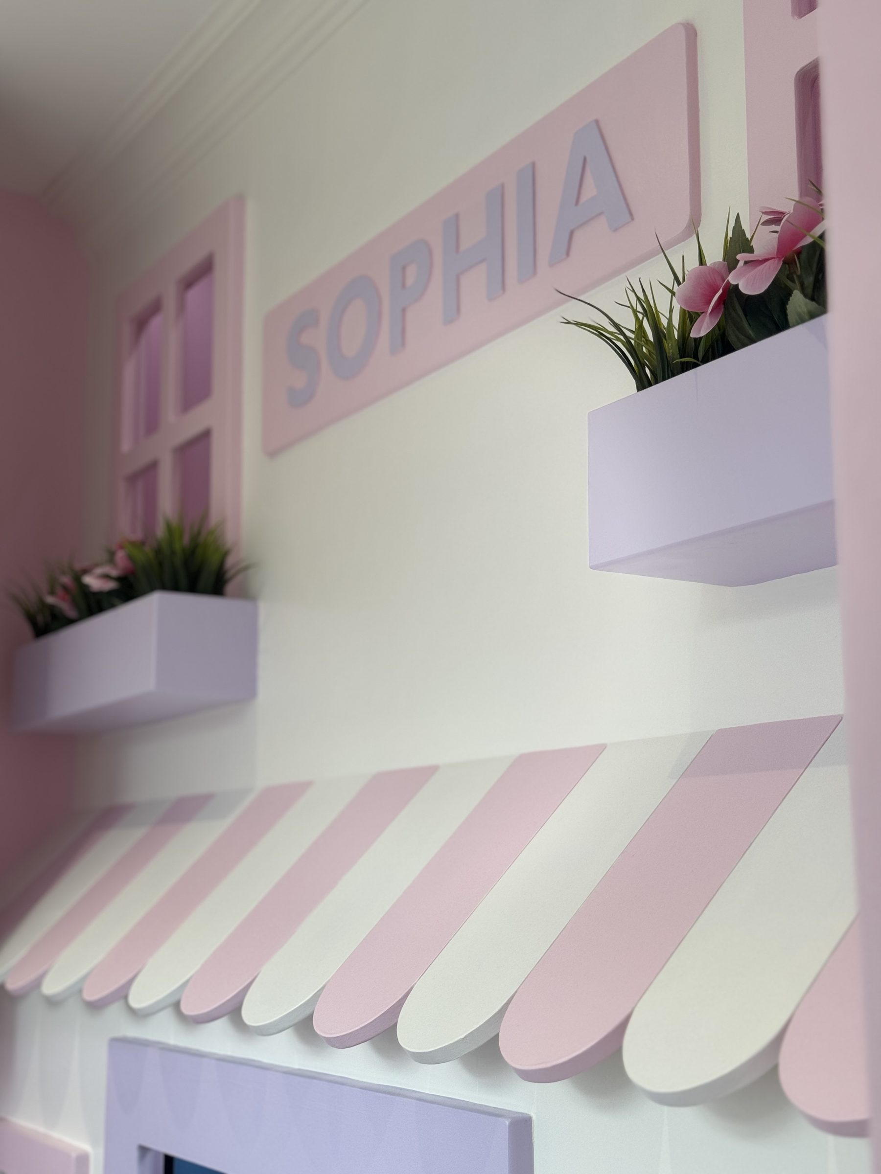 Painted awning, planters and name sign in a child's bedroom